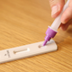 In this photo illustration a man uses a COVID-19 rapid antigen test kit at home on September 29, 2021.
